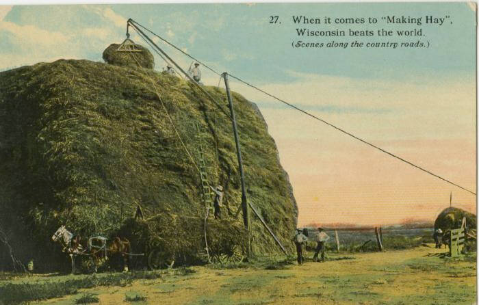 Postcard of a large mound of hay, tinted green in Wisconsin.